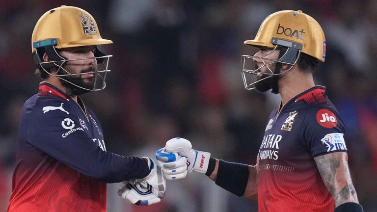 Royal Challengers Bengaluru's captain Rajat Patidar, left, fist bumps with his batting partner Virat Kohli during the IPL cricket final 