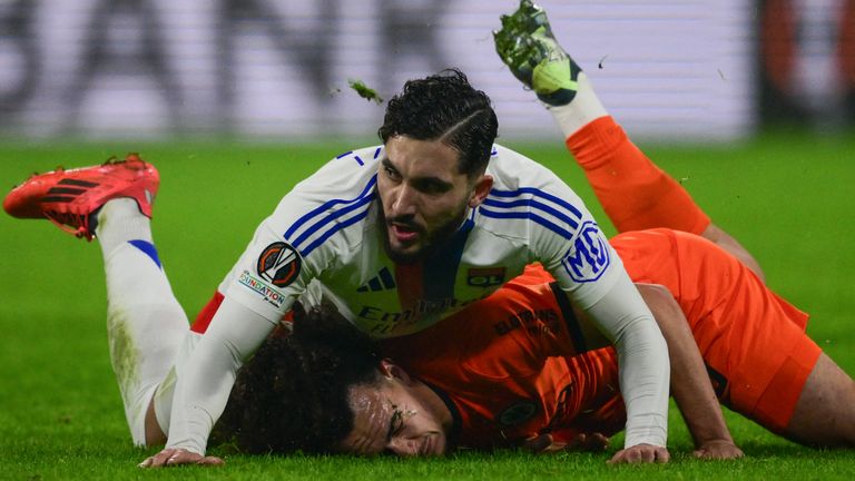 Rayan Cherki (L) fights for the ball with Eintracht Frankfurt's Arthur Theate