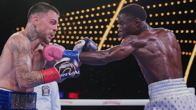 Richardson Hitchins, right, punches Australia's George Kambosos Jr. during the third round of a welterweight title boxing match Saturday, June 14, 2025, in New York. (AP Photo/Frank Franklin II)
