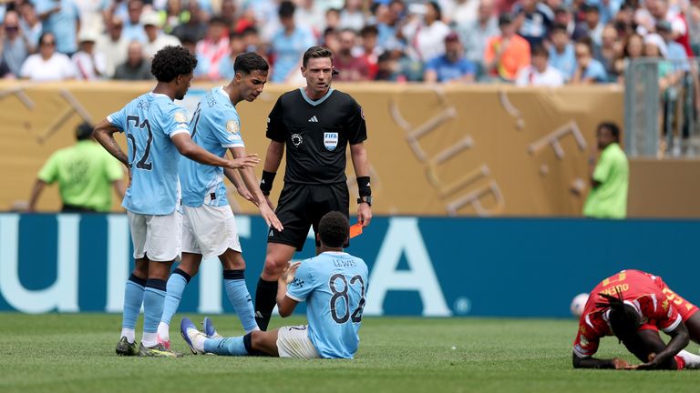 Rico Lewis of Manchester City is shown a red card by referee Ramon Abatti during the FIFA Club World Cup 2025 match against Wydad Casablanca