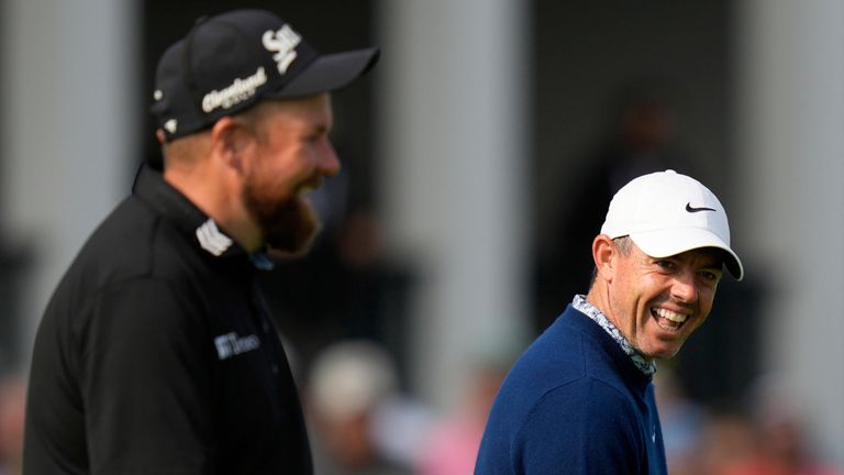Rory McIlroy from Northern Ireland, right, laughs with Shane Lowry from Ireland, while walking at 18 Green during training ahead of the American Golf Tournament in the Oakmont County Club on Tuesday, June 10, 2025, in Oakmont, Pa. (AP Photo/Seth Wenig)