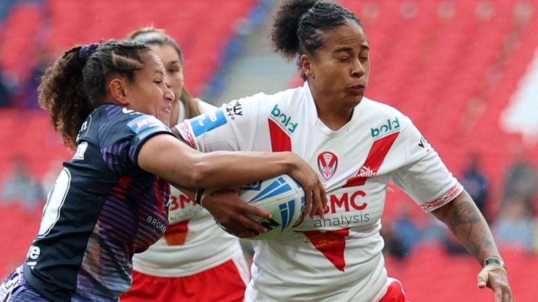 St Helens' Channy Crowl is tackled by Wigan Warriors' Shaniah Power during the Women's Challenge Cup final