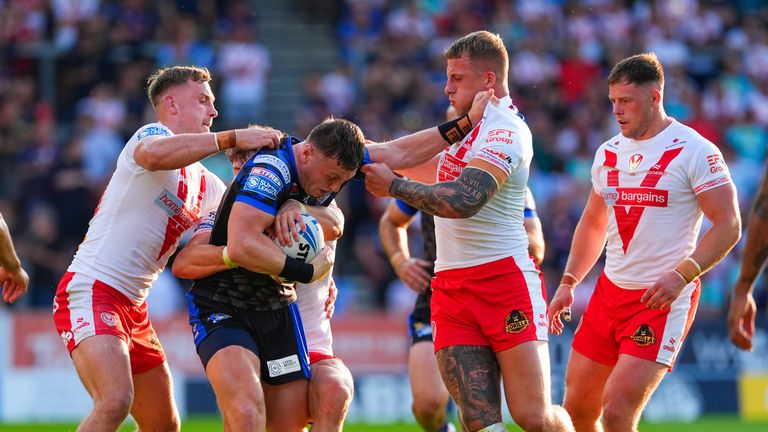 Picture by Olly Hassell/SWpix.com - 20/06/2025 - Rugby League - Betfred Super League Round 15 - St Helens v Leeds Rhinos - The Totally Wicked Stadium, St Helens, England - Harry Newman of Leeds is tackled by Jake Wingfield of St Helens