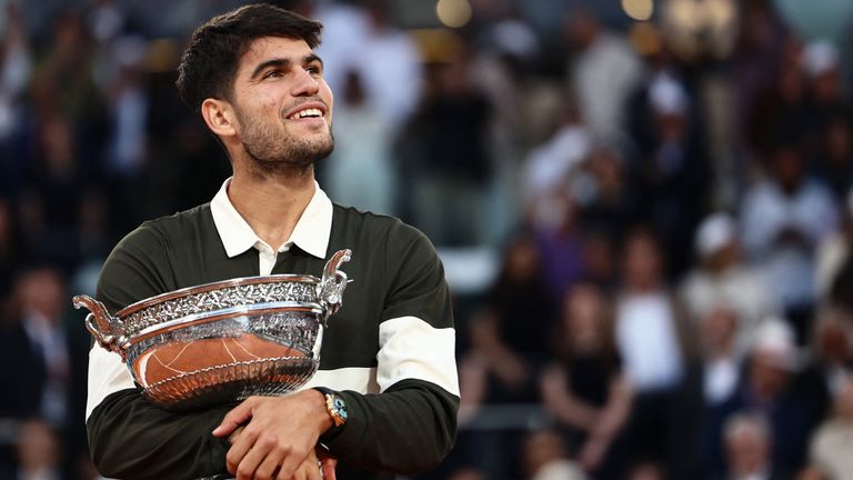 Spain's Carlos Alcaraz holds the trophy after winning the men's singles final match against Italy's Jannik Sinner on day 15 of the French Op