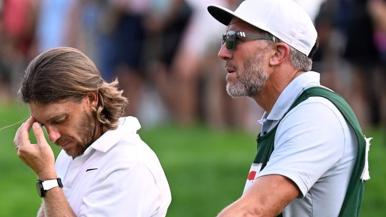 Tommy Fleetwood, from England, reacts as Keegan Bradley prepares to putt for the win during the final round of the Travelers Championship golf tournament at TPC River Highlands, Sunday, June 22, 2025, in Cromwell, Conn. At right is Fleetwood's caddie Ian Finnis. (AP Photo/Jessica Hill)