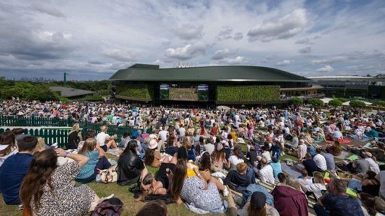 The crowd on The Hill watching the Gentlemen's Singles final on the large screen on the back of No.1 Court on day thirteen of Wimbledon at T