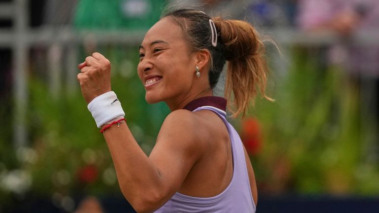 China's Zheng Qinwen reacts after beating Britain's Emma Raducanu in a women's singles quarterfinal match at the Queens Club grass court ten