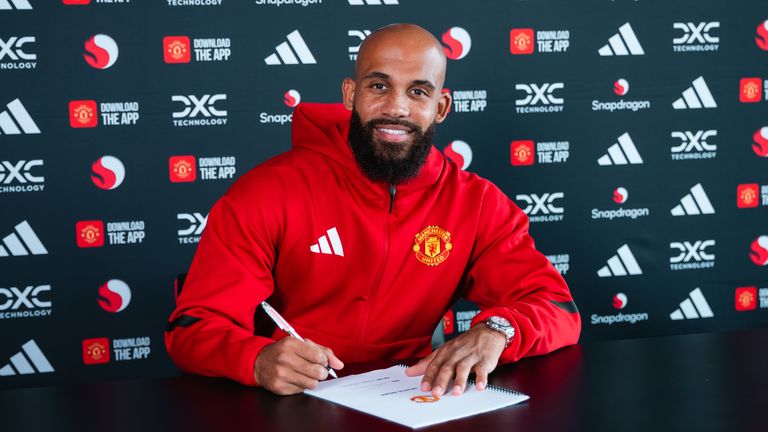 Manchester United's Bryan Mbeumo poses after signing for the club