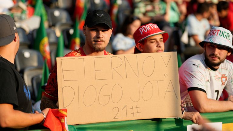 A fan holds a sign with the Portuguese word "Eternal" in memory of Portuguese international footballer Diogo Jota, who lost his life in a car crash in Spain, before the Euro 2025, group B, soccer match between Spain and Portugal at Stadion Wankdorf in Bern, Switzerland, Thursday, July 3, 2025. (AP Photo/Martin Meissner)