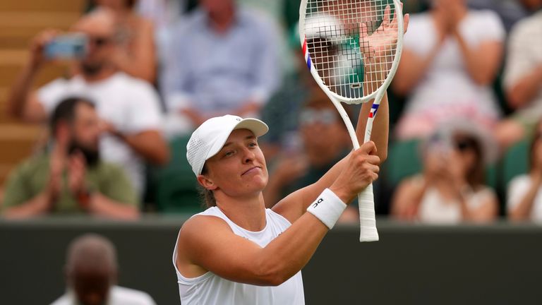 Iga Swiatek of Poland celebrates winning her first round women's single match against Polina Kudermetova of Russia at the Wimbledon Tennis Championships in London, Tuesday, July 1, 2025.(AP Photo/Joanna Chan)