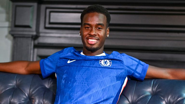 Jamie Gittens poses in a Chelsea shirt after signing for the Premier League club from Borussia Dortmund