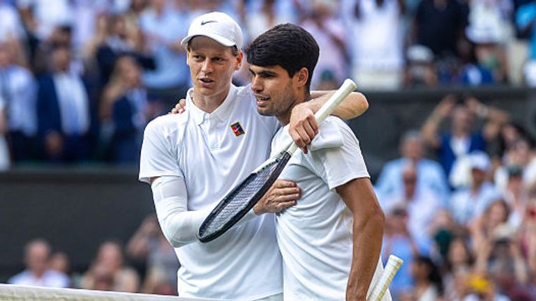 Winner Jannik Sinner of Italy and Carlos Alcaraz of Spain embrace at the net after the Gentlemen's Singles Final on Centre Court during the 