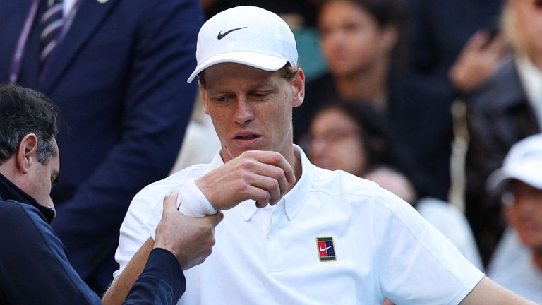 Italy's Jannik Sinner reacts as he receives medical treatment during his men's singles fourth round tennis match against Bulgaria's Grigor Dimitrov on the eighth day of the 2025 Wimbledon Championships at The All England Lawn Tennis and Croquet Club in Wimbledon, southwest London, on July 7, 2025. (Photo by Adrian Dennis / AFP) / RESTRICTED TO EDITORIAL USE