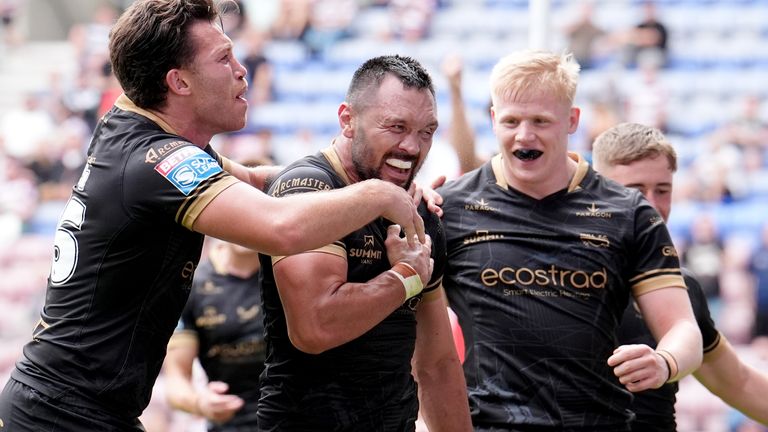Hull FC's Jordan Rapana (centre) celebrates after scoring a try against Wigan Warriors