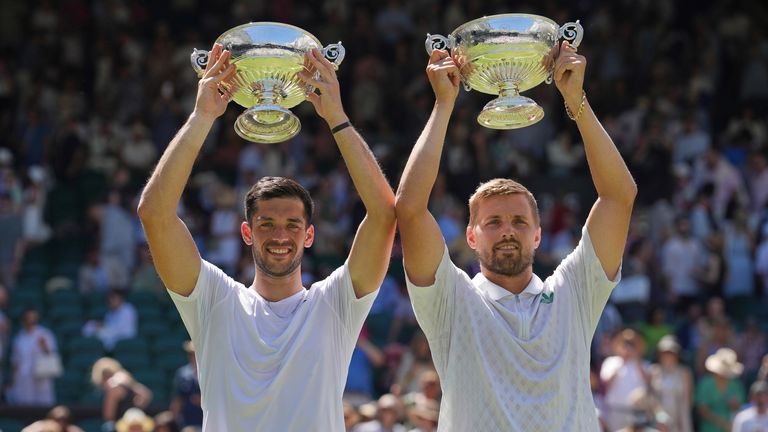 Julian Cash of Britain, left, and Lloyd Glasspool of Britain celebrate with the trophy after winning the men's doubles final match against R