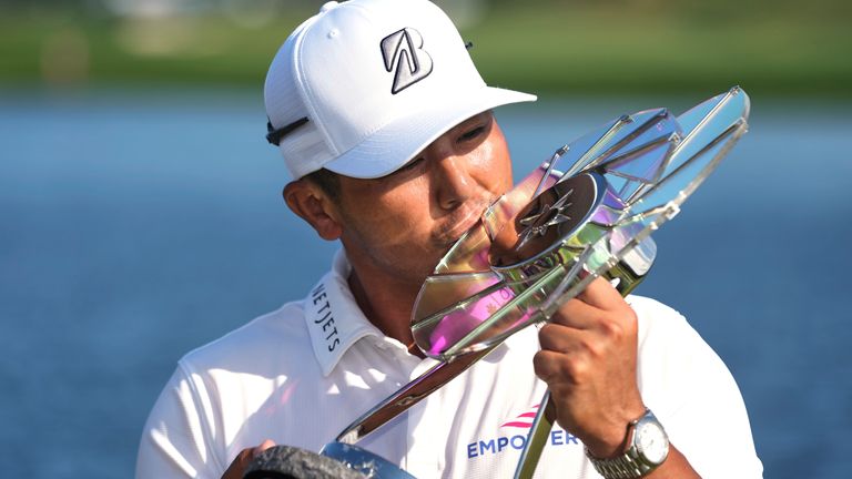 Kurt Kitayama, left, is presented with a trophy after winning the 3M Open