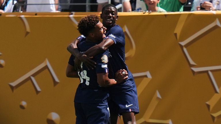 Paris Saint-Germain's Ousmane Dembele, right, and Desire Doue (14) celebrate after Dembele scored their side's second goal during the Club World Cup semifinal soccer match between PSG and Real Madrid in East Rutherford, N.J., Wednesday, July 9, 2025. (AP Photo/Seth Wenig)