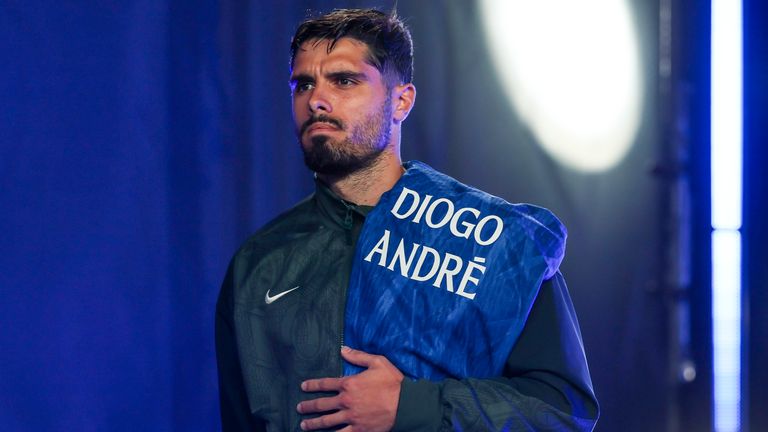 Pedro Neto of Chelsea holds a jersey with the names Diogo and Andre to observe a moment of silence in tribute to Diogo Jota and his brother