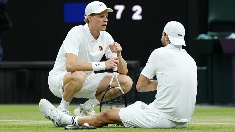 Jannik Sinner (left) consoles an injured Grigor Dimitrov during their match at 2025 Wimbledon Championships on July 7 