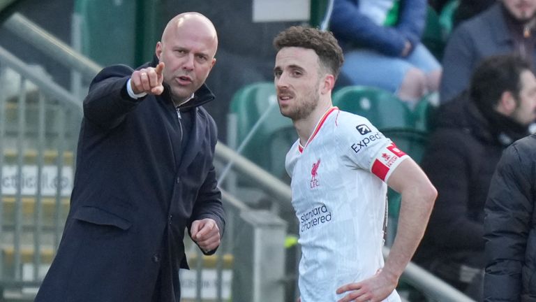 Liverpool's head coach Arne Slot talks to Diogo Jota 