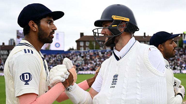 Chris Woakes is congratulated by Washington Sundar after taking his place on the field despite having one arm in a sling