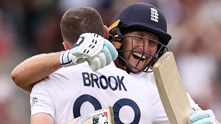 England's Harry Brook (L) celebrates his 100 with England's Joe Root (R) on day four of the fifth Test cricket match between England and India at The Oval in London on August 3, 2025. (Photo by HENRY NICHOLLS / AFP) / RESTRICTED TO EDITORIAL USE. NO ASSOCIATION WITH DIRECT COMPETITOR OF SPONSOR, PARTNER, OR SUPPLIER OF THE ECB