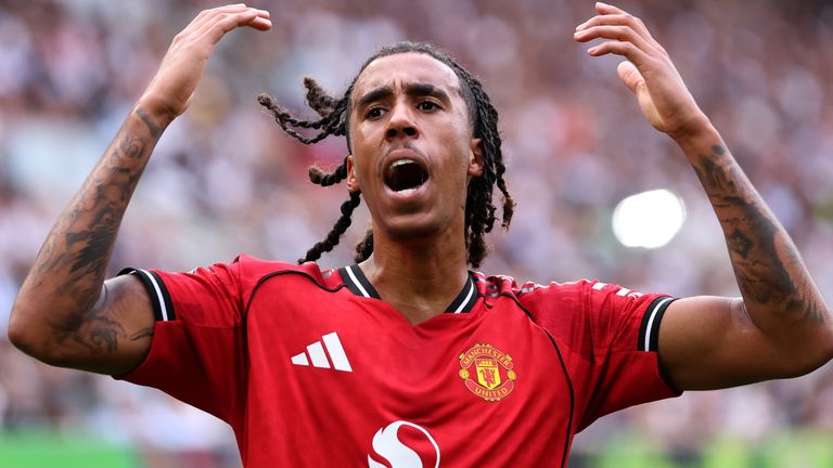Manchester united defender Leny Yoro lifts both arms during match against Fulham at Craven Cottage on August 24, 2025