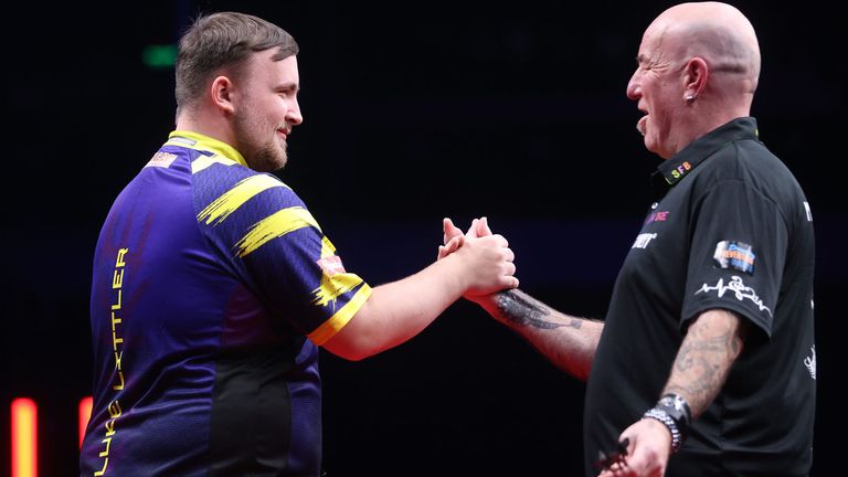 Luke Littler, left, and Mark Cleaver shake hands after the match (Credit: PDC)