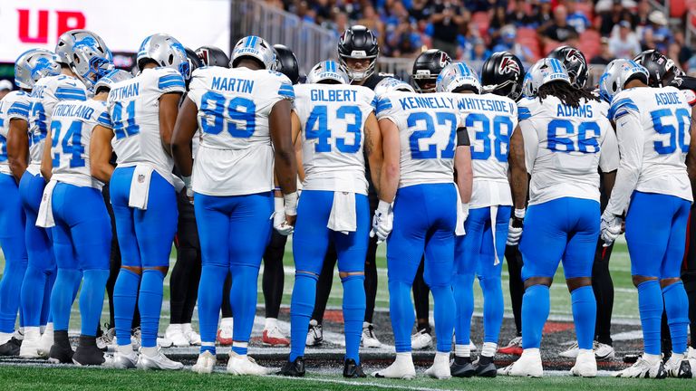 Players gather as the NFL preseason game between Detroit and Atlanta is  suspended following Morice Norris' injury