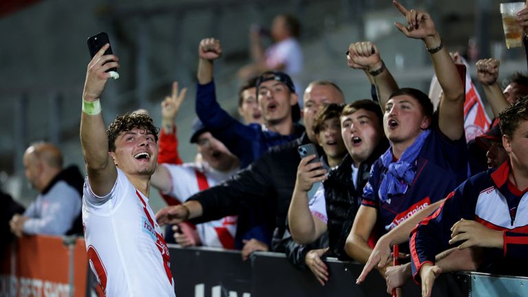 Owen Dagnall of St Helens takes a selfie with fans after the match