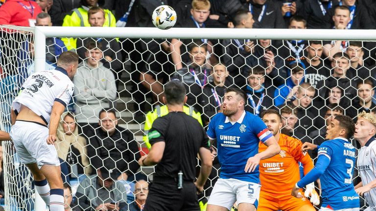 Dundee's Clark Robertson takes a headed shot but it comes off the post vs Rangers