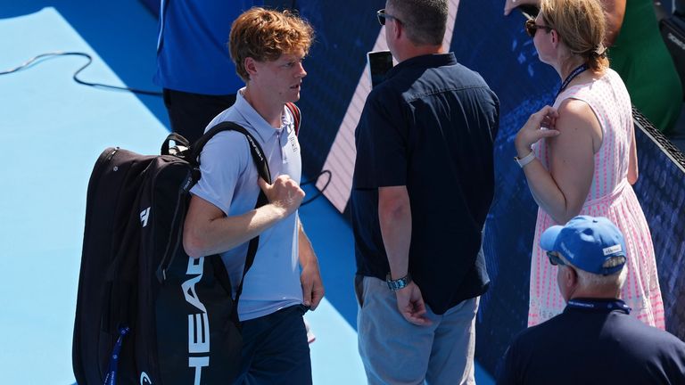 Jannik Sinner leaves the court after retiring from the Cincinnati Open through illness