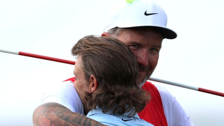 ATLANTA, GA - AUGUST 24: Tommy Fleetwood of England celebrates with his caddie after winning the PGA Tour Championship