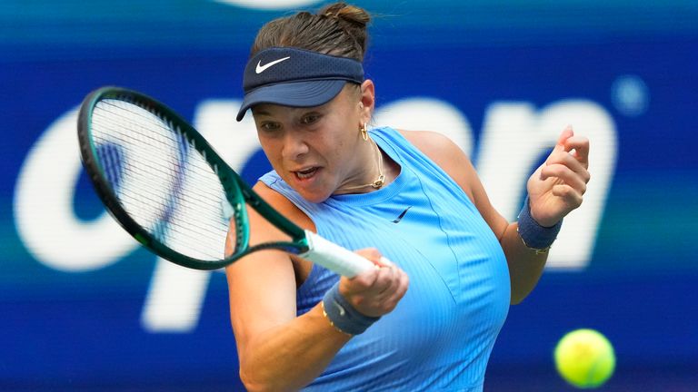 Amanda Anisimova, of the United States, returns a shot to Iga Swiatek, of Poland, during the quarterfinal round of the U.S. Open tennis championships, Wednesday, Sept. 3, 2025, in New York. (AP Photo/Yuki Iwamura)