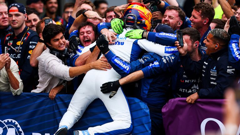 Carlos Sainz jumps into his Williams mechanics to celebrate his first podium for the team in Baku