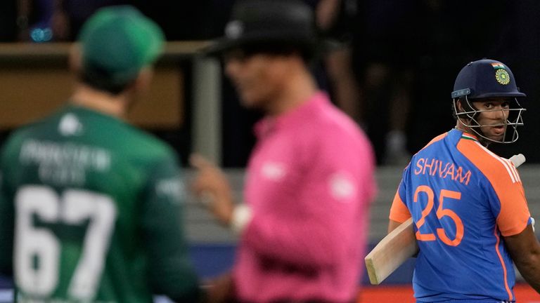 India's captain Suryakumar Yadav, left, and batting partner Shivam Dube, right, leave the field after their win in the Asia Cup cricket match against Pakistan at Dubai International Cricket Stadium in Dubai, United Arab Emirates, Sunday, Sept. 14, 2025. (AP Photo/Fatima Shbair)