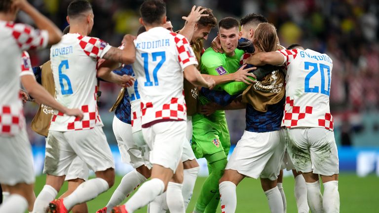 Croatia players celebrate with goalkeeper Dominik Livakovic after they beat Brazil in a penalty shootout at the 2018 World Cup