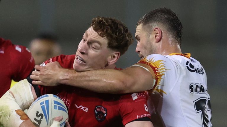 Salford Red Devils' Dan Russell in action with Catalans Dragons' Bayley Sironen