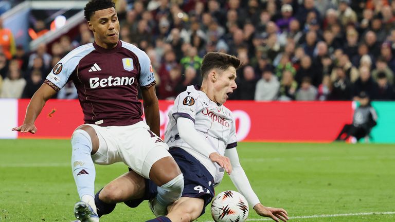 Aston Villa's Ollie Watkins, left, duels for the ball with Bologna's Martin Vitik during the Europa League