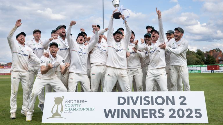 Ian Holland of Leicestershire lifts the County Championship Division Two Trophy aloft 