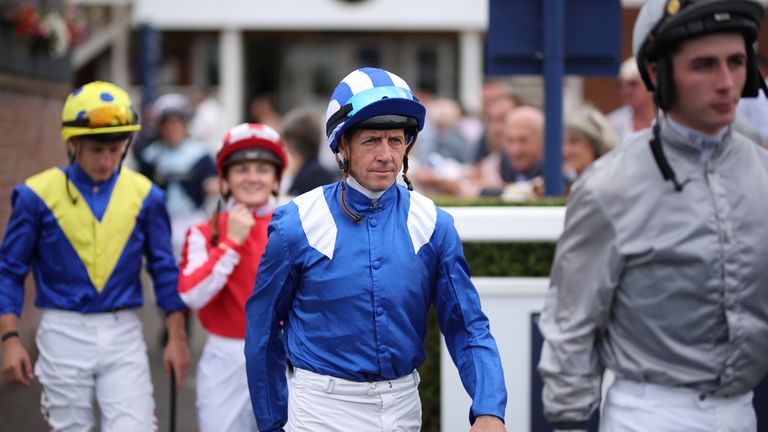 Jockey Jim Crowley (centre) walks into the parade ring ahead of the Visit Malta Hungerford Stakes