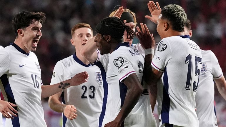 Noni Madueke is joined in celebration by his England team-mates