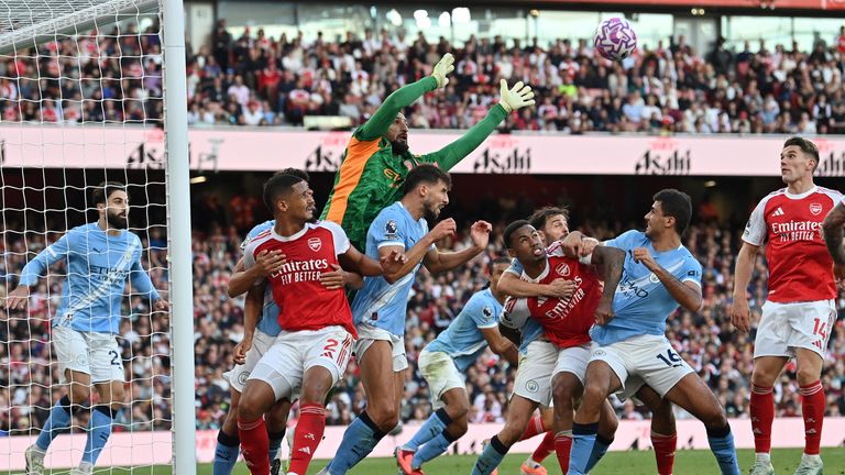 Manchester City's Italian goalkeeper #25 Gianluigi Donnarumma reaches for the ball during the English Premier League football match between Arsenal and Manchester City at the Emirates Stadium in London on September 21, 2025. (Photo by Glyn KIRK / AFP) / RESTRICTED TO EDITORIAL USE. No use with unauthorized audio, video, data, fixture lists, club/league logos or 'live' services. Online in-match use limited to 120 images. An additional 40 images may be used in extra time. No video emulation. Social media in-match use limited to 120 images. An additional 40 images may be used in extra time. No use in betting publications, games or single club/league/player publications. / 