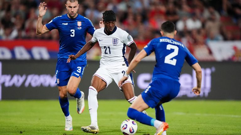 Noni Madueke lifts the ball over the goalkeeper to double England's lead over Serbia in Belgrade