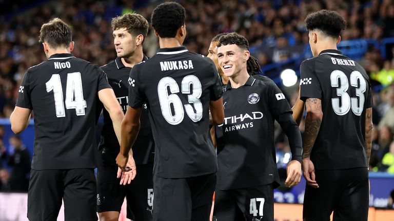 Phil Foden celebrates with team-mates after putting Man City ahead against Huddersfield in the Carabao Cup