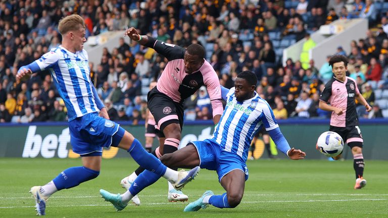 Richard Kone (centre) of Queens Park Rangers shoots under pressure from Ernie Weaver  and Dominic Iorfa 