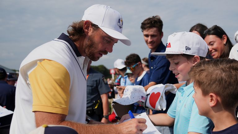 Europe's Tommy Fleetwood signs autographs during a practice round ahead of the 2025 Ryder Cup (Associated Press)
