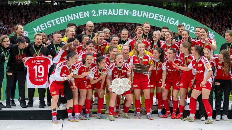 Dina Orschmann from 1. FC Union Berlin holds the championship trophy in her hands 