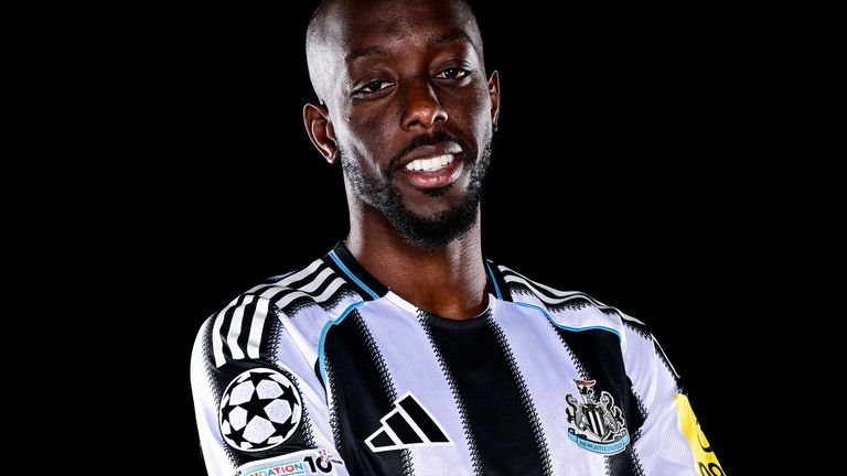 Yoane Wissa poses for photographs after signing for Newcastle United