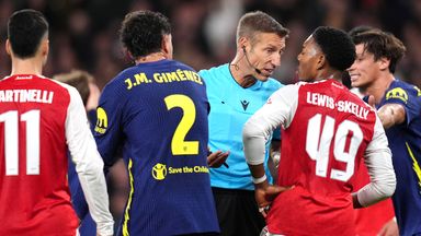 Referee Davide Massa speaks to Arsenal's Myles Lewis-Skelly